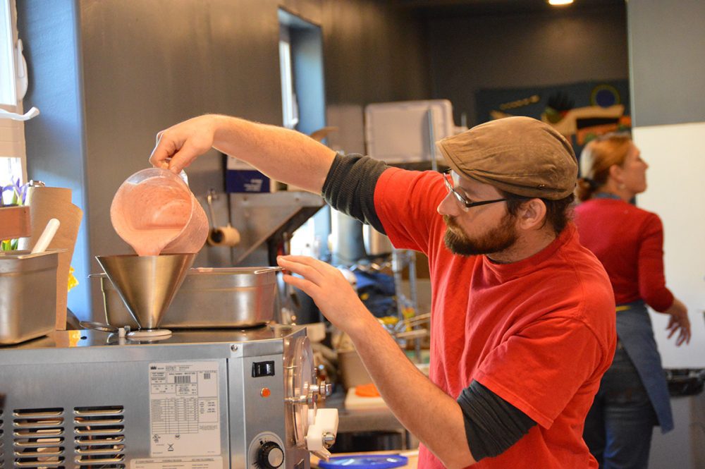 Buttercup employee pours mixture into ice cream machine