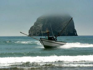 Dory boat on the water in front of Haystack Rock