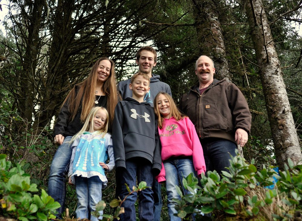 Happy group poses in the woods while geocaching in Tillamook County