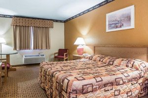 Hotel bedroom with pink bedspread
