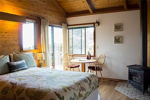 Bedroom with windows and wood stove