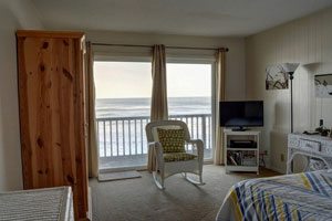 Bedroom with television and rocking chair, window overlooked the ocean