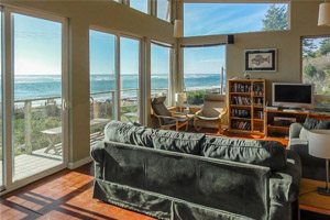 Living room with lots of windows overlooking beach