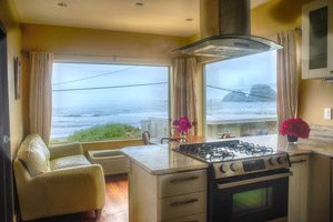 Kitchen and living room with windows looking out over the beach