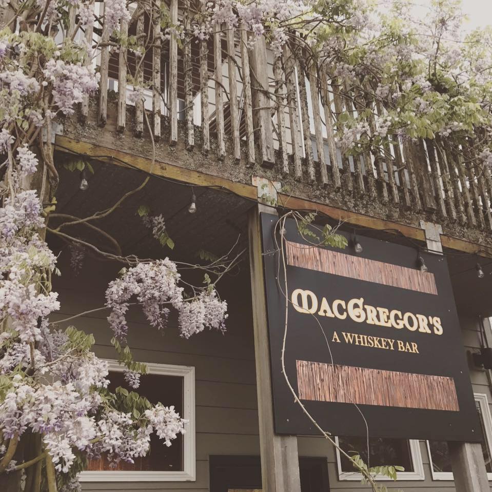McGregor's - A Whiskey Bar sign on porch with wisteria