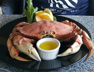 Whole cooked Dungeness crab with a ramekin of butter