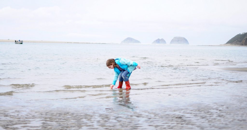 Child playing in the ocean at Netarts Bay