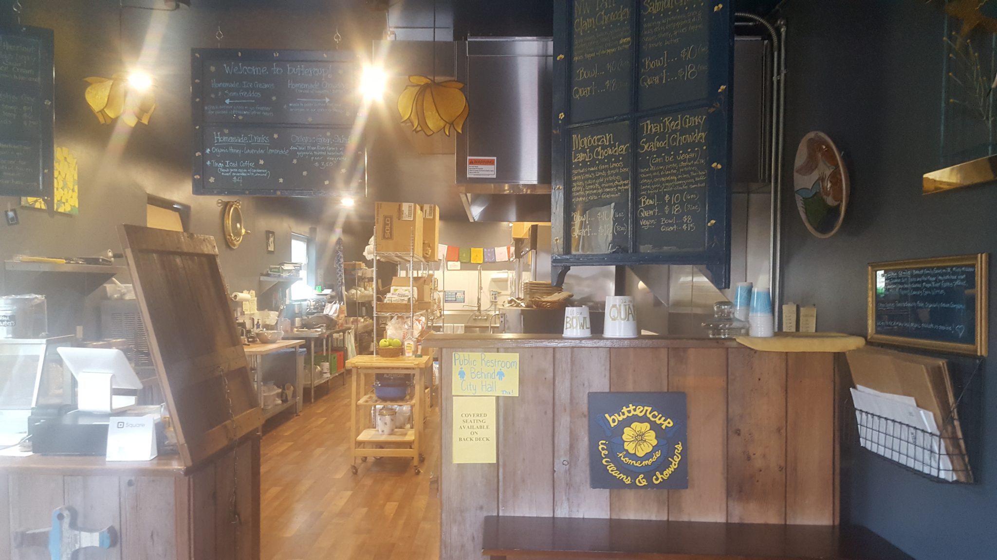 Inside of the Buttercup shop—counter for ordering with menus written on chalkboards overhead