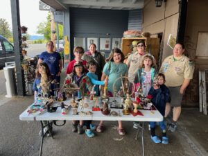Cub Scout Pack 122 displays their trophies made from upcycled material at Heart of Cartm
