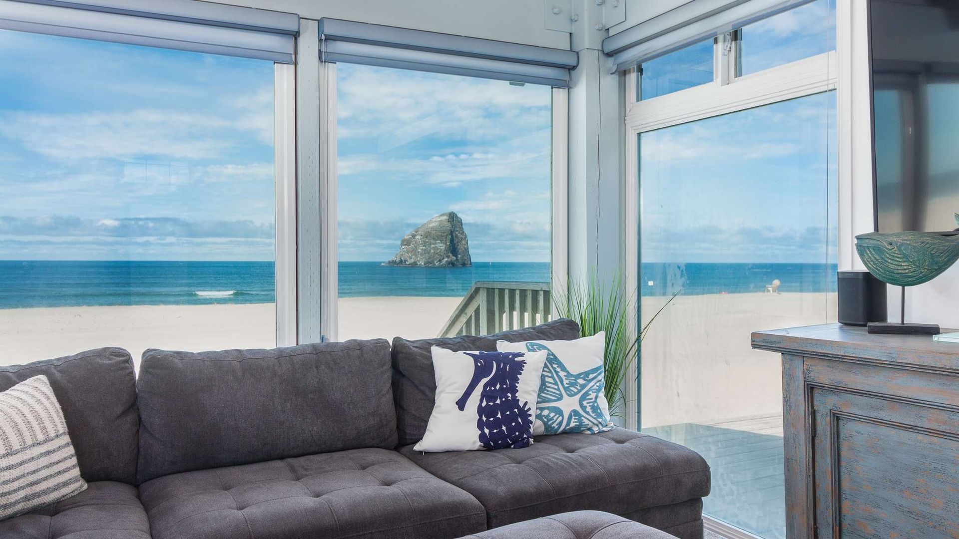 Kiwanda Coastal Properties indoor room couch windows coast