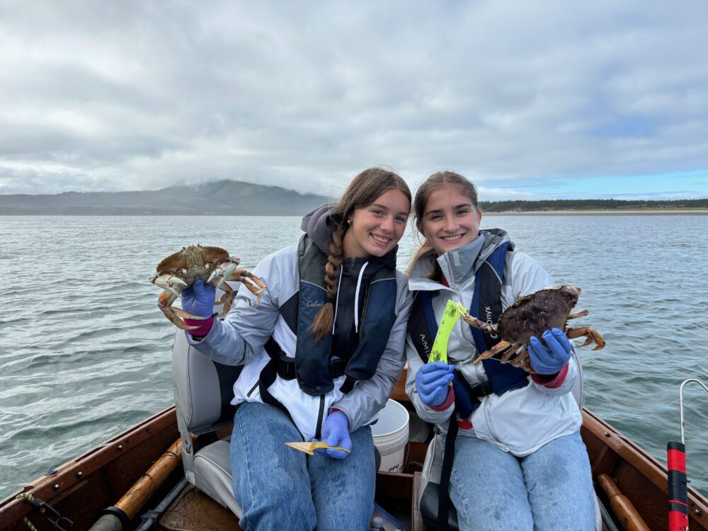two girls crabbing boat netarts
