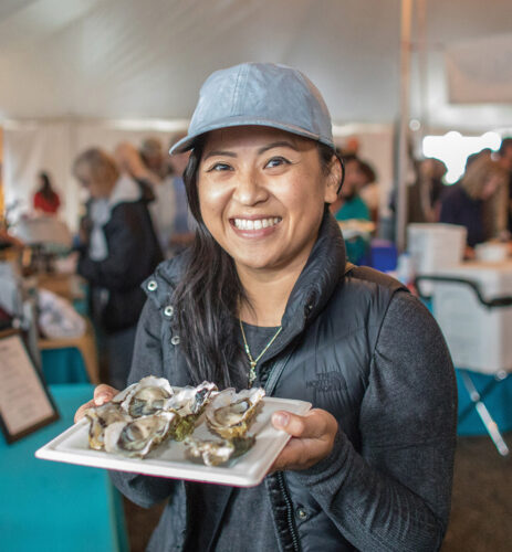 oyster platter server woman indoor food festival