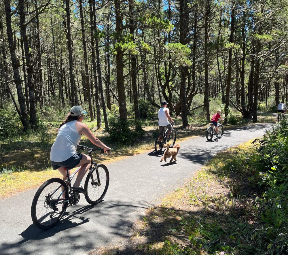 Nehalem Bay bikers forest paved path